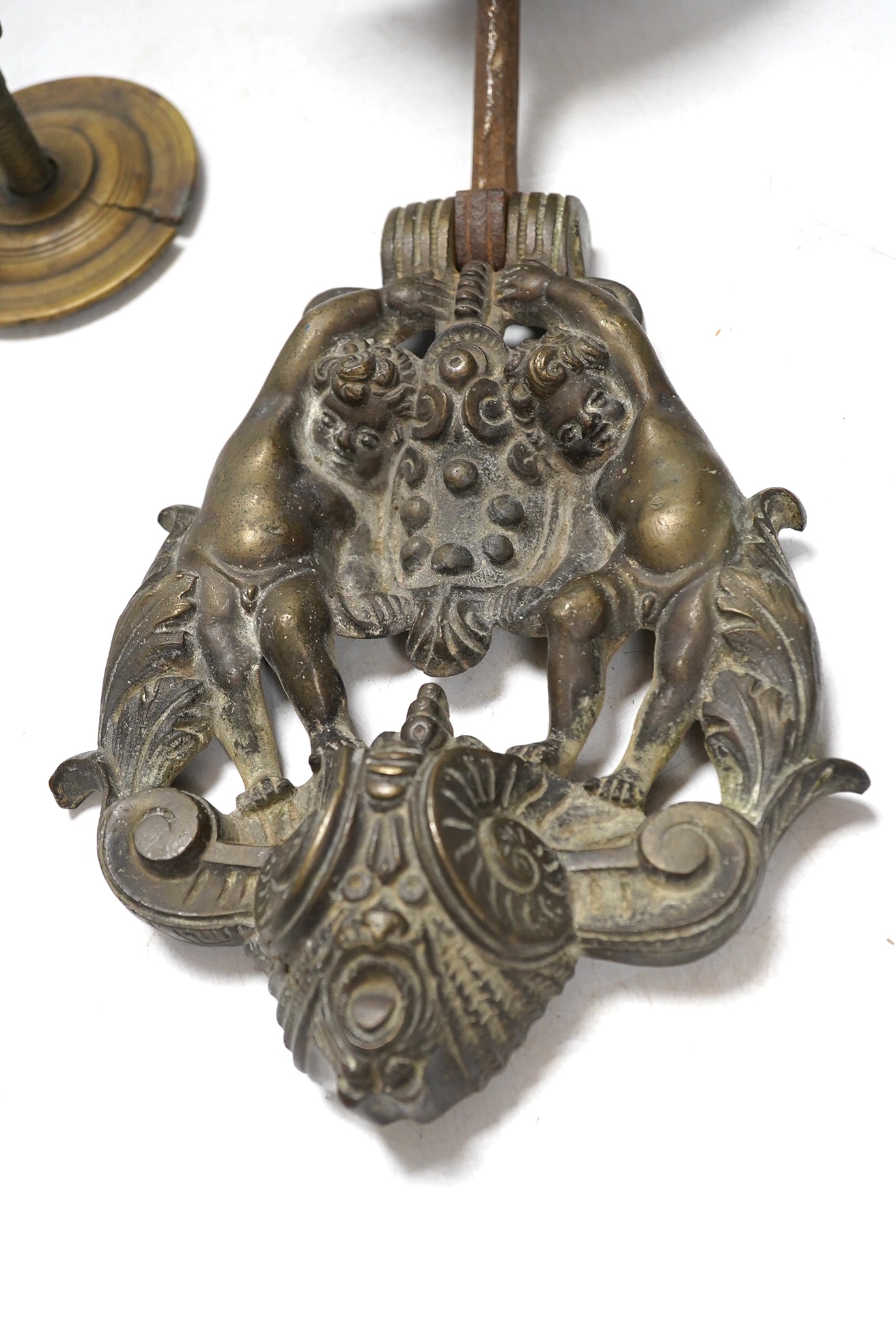 An Italian bronze satyr door knocker, circa 1700, together with a brass handle, knocker drop 22cm. Condition - fair